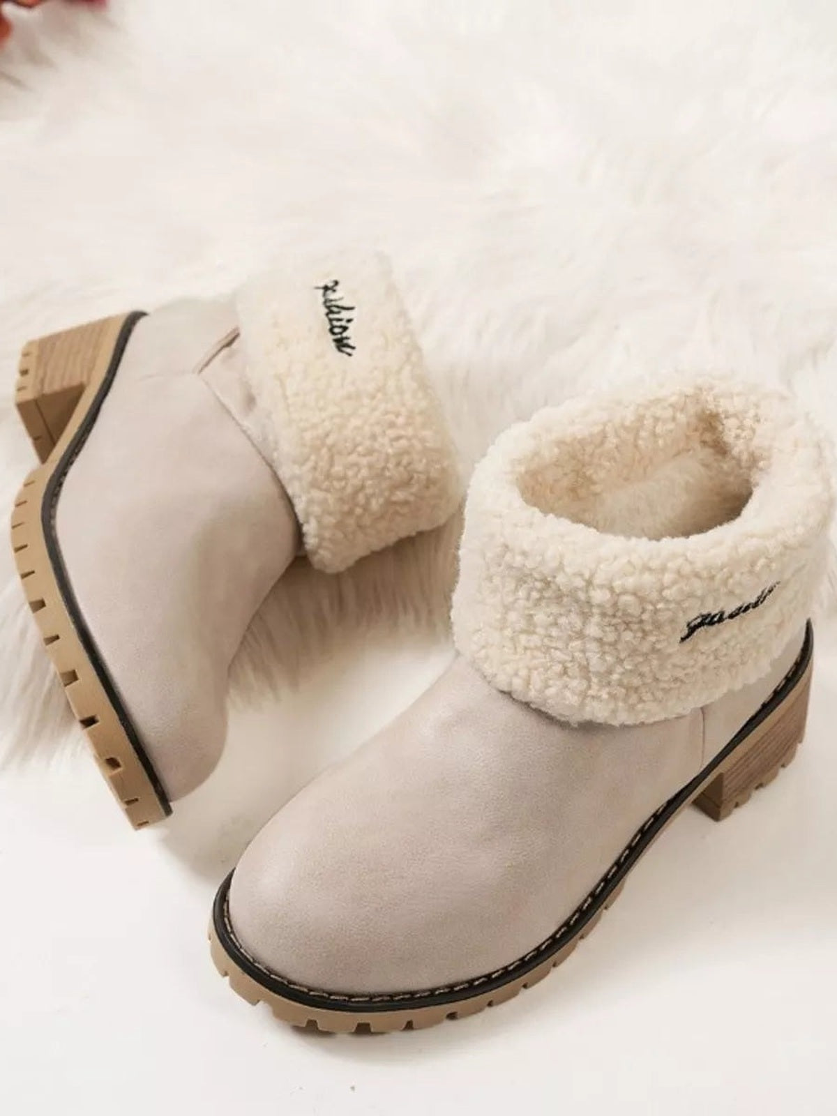 Cream PU leather round toe block heel boots feature plush fluffy cuffs, low stacked heels, black welt trim, and rugged rubber lug soles.