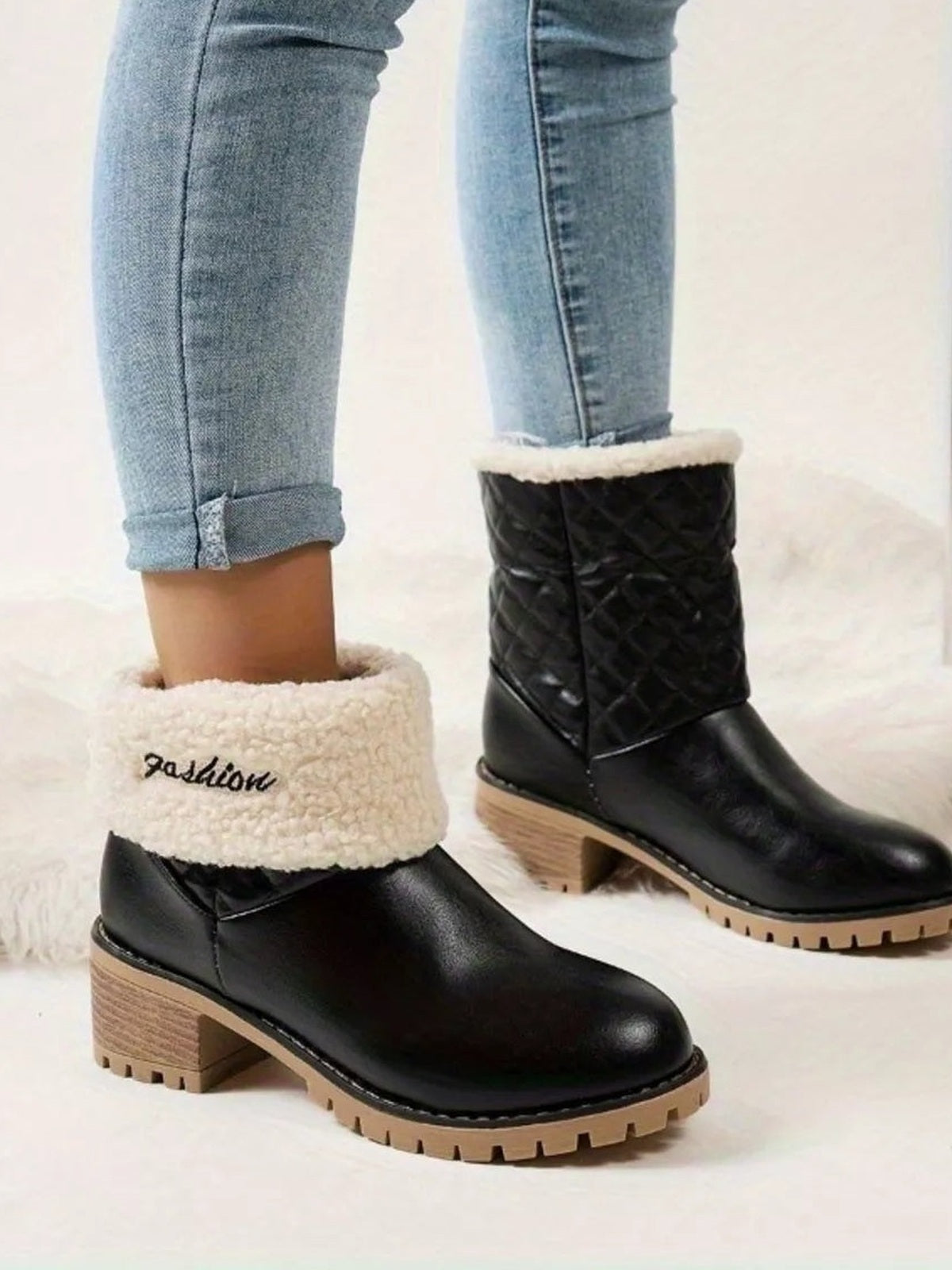A model wears black PU leather round-toe block heel boots with quilted shafts, fluffy cuffs, low heels, and rugged rubber lug soles.