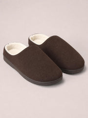 Brown suede round toe flat slippers feature a slip-on design, soft cream lining, stitched edges, and sturdy rubber soles.