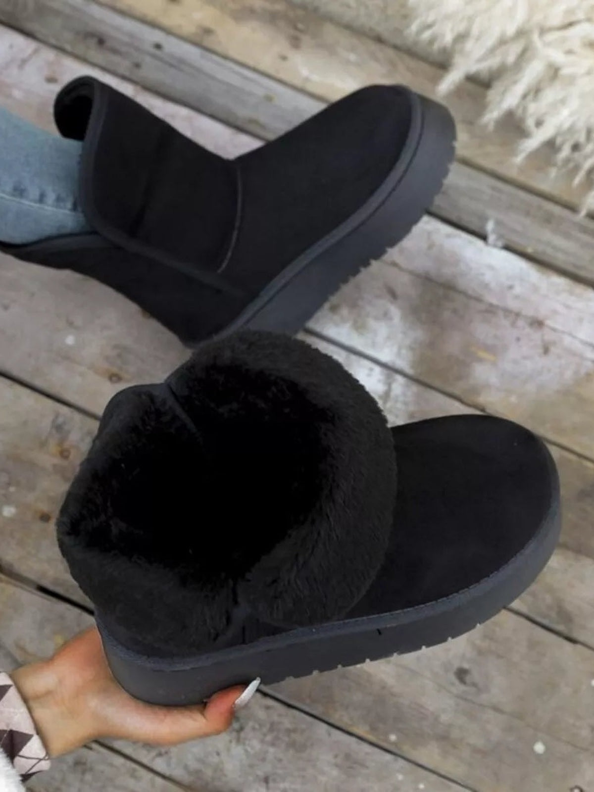 Black round-toe platform boots feature a low flat profile, soft faux-fur lining, smooth PU leather uppers, and thick rubber lug soles.