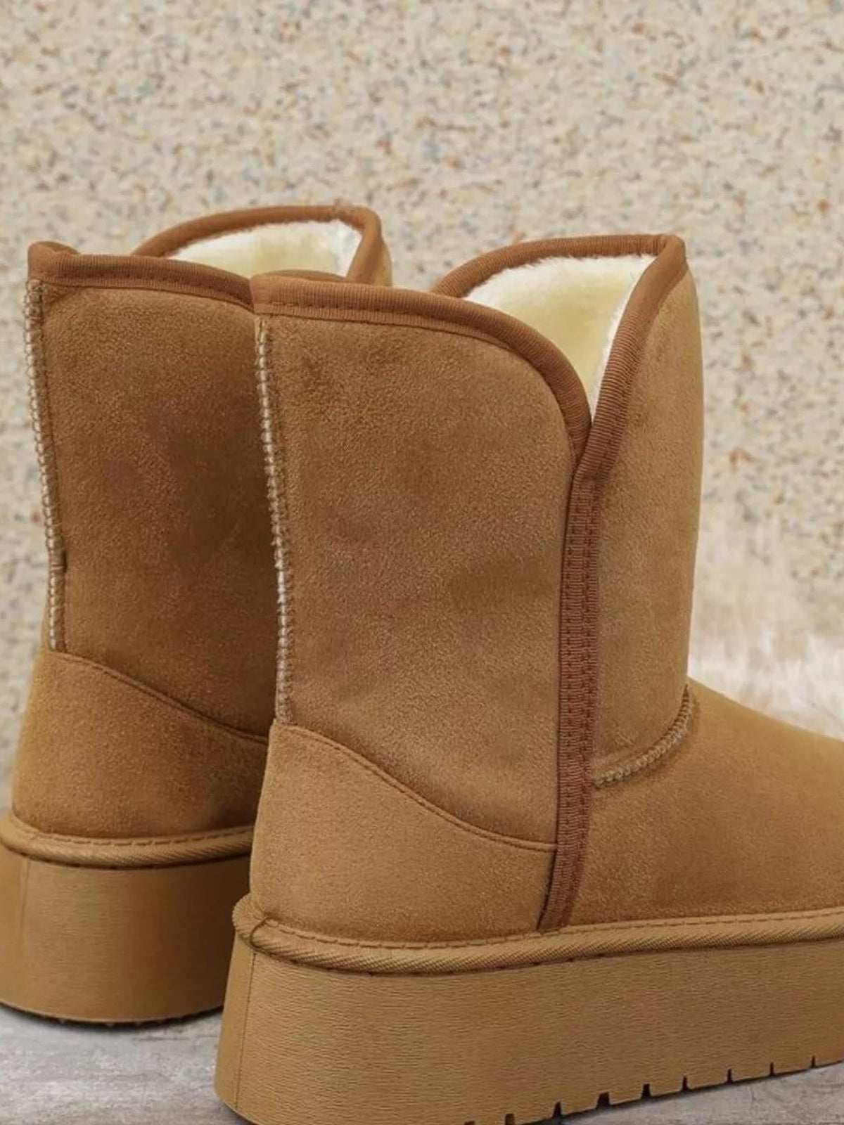 Tan PU leather platform boots feature plush lining, tall rounded shafts, stitched panel construction, and thick rubber soles with deep treads.