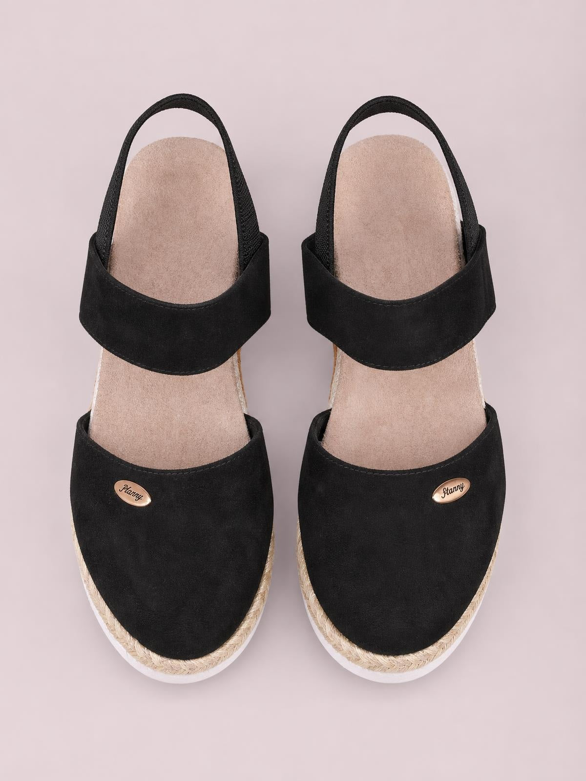 Black canvas round-toe wedge sandals feature broad upper straps, slingback ankle straps, braided midsoles, and white rubber outsoles.