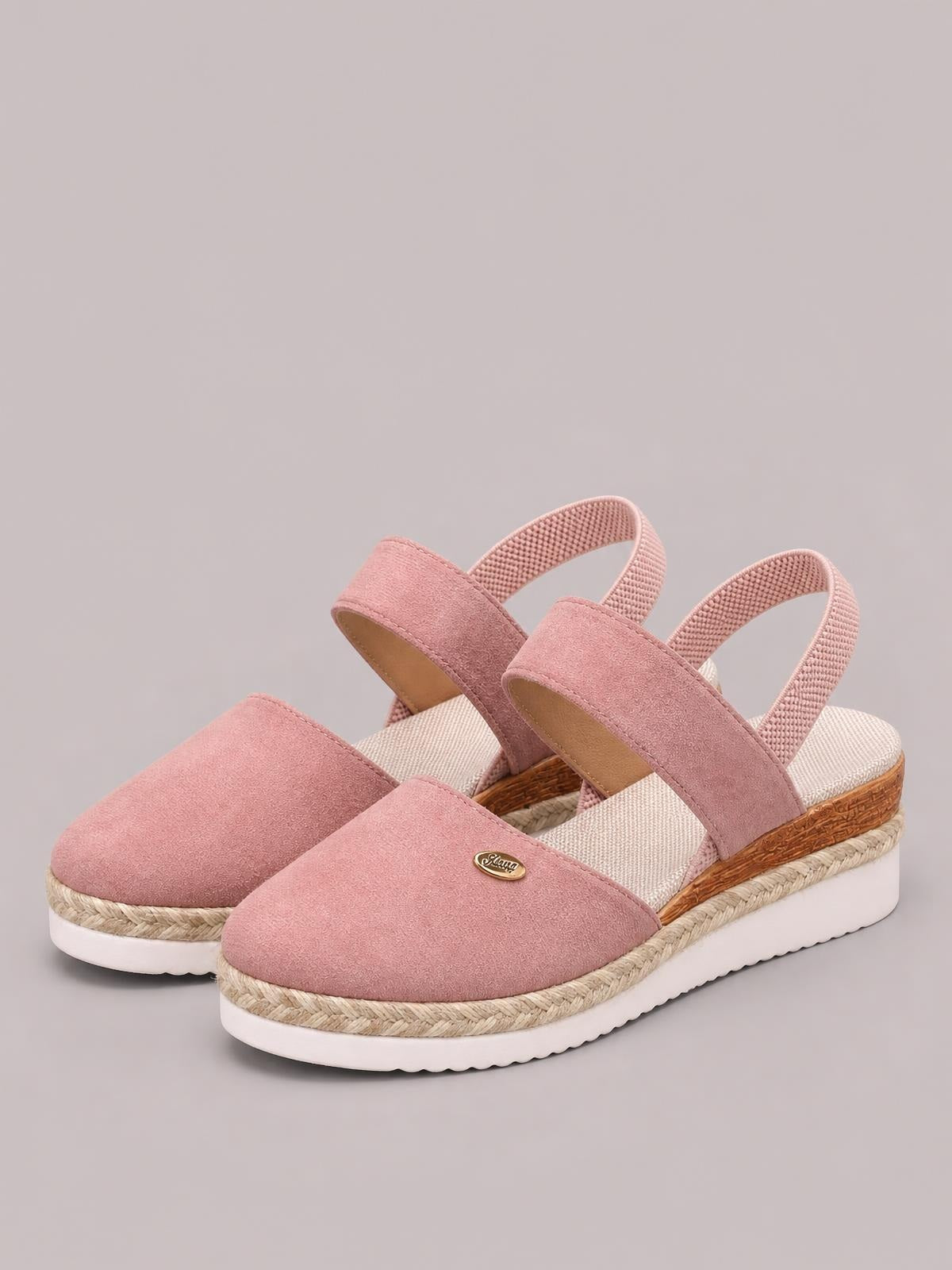 Pink round-toe wedge sandals with broad closed-toe uppers, slingback straps, espadrille-style trim, and white rubber soles.