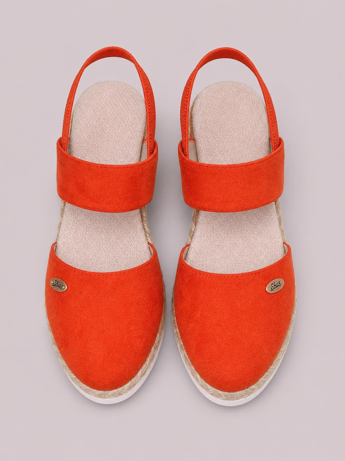 Bright orange-red round-toe wedge sandals feature wide canvas straps, slingback ankle straps, woven midsoles, and white rubber soles.