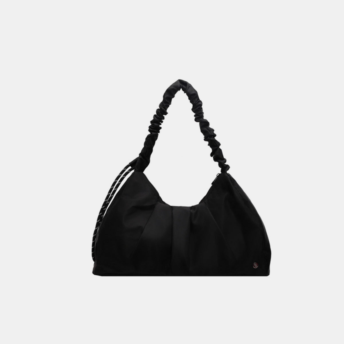 Black ruched large tote bag in canvas with a softly structured, gathered body, elongated silhouette, and distinctive ruched shoulder handle.