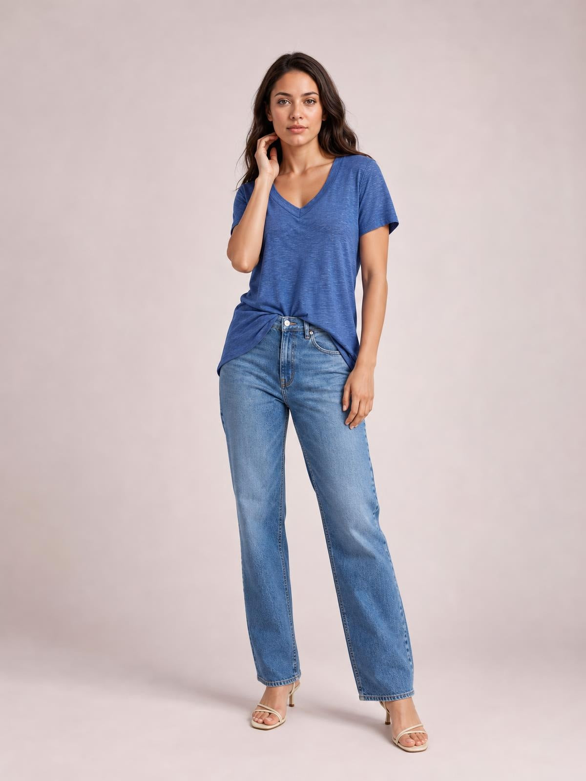 Model poses in a blue ruched V-neck short sleeve T-shirt with a relaxed straight silhouette, lightly textured fabric, and a front-tucked hem.