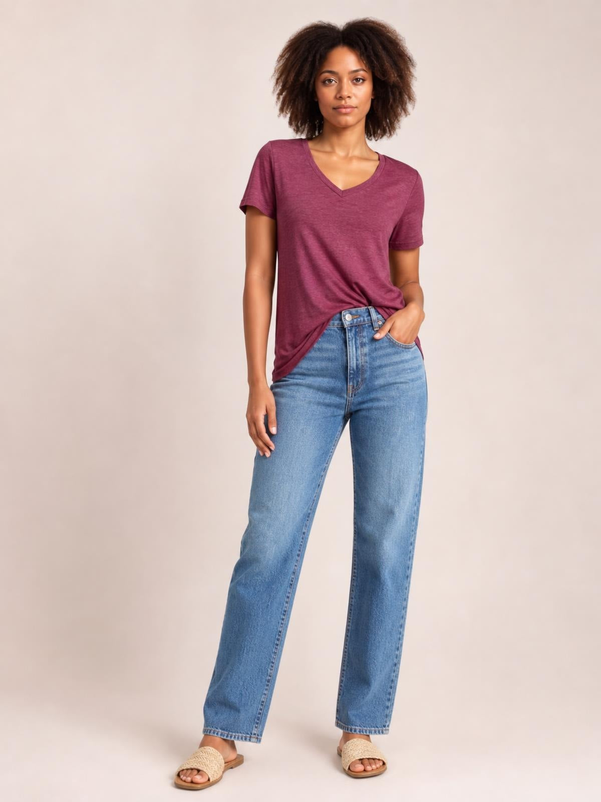 Model wears a burgundy ruched V-neck short sleeve T-shirt with a relaxed straight silhouette and slight draping at the waist.