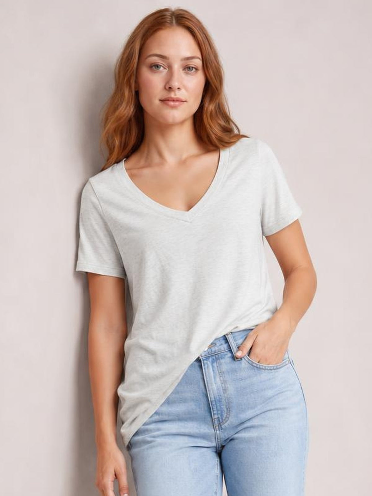Model wears a light gray ruched V-neck short sleeve T-shirt with a relaxed silhouette, visible seam construction, and a slightly stretchy drape.