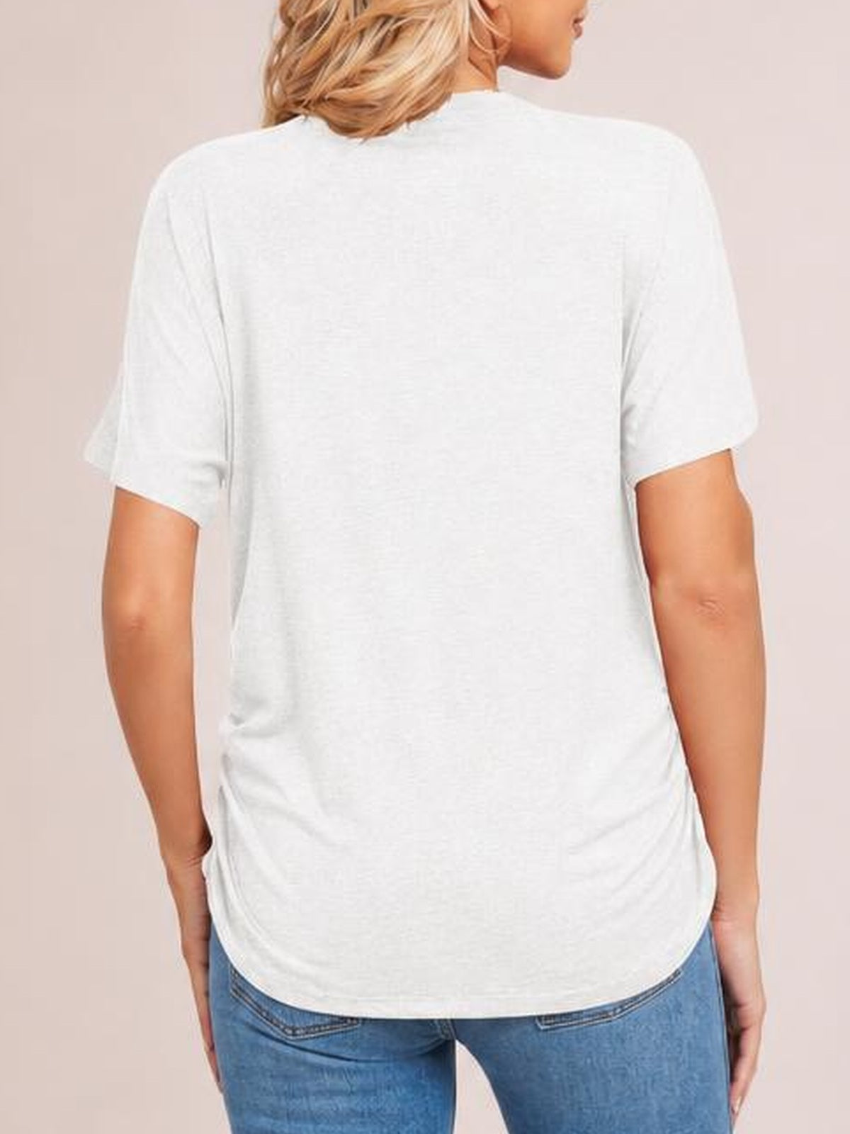 Model shown from the back wearing a white short-sleeve T-shirt with a relaxed silhouette, smooth construction, and a gently curved hem.
