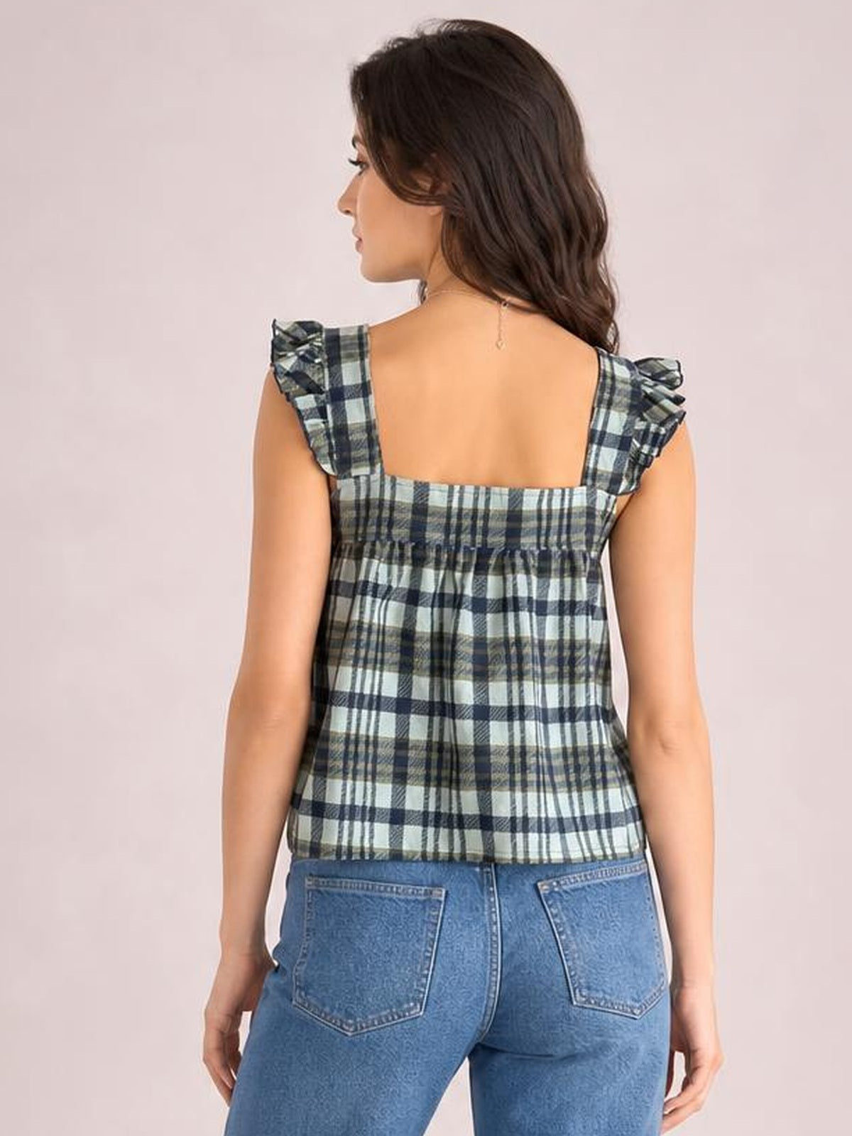 Model turned away showcases a plaid square neck tank with ruffled shoulder straps, a gathered relaxed silhouette, and blue, white, and gray checks.
