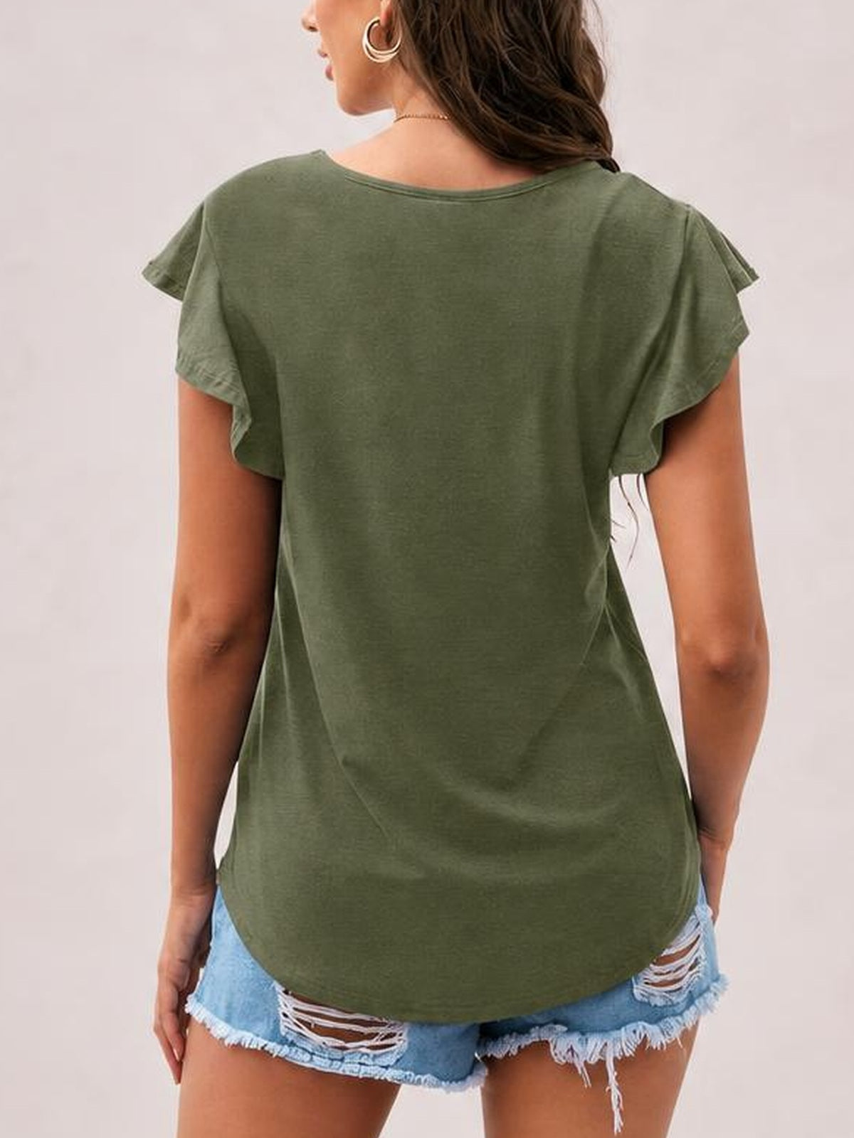 Model shown from behind wearing an olive-green ruffled round-neck blouse with fluttering cap sleeves, a relaxed silhouette, and a curved hem.