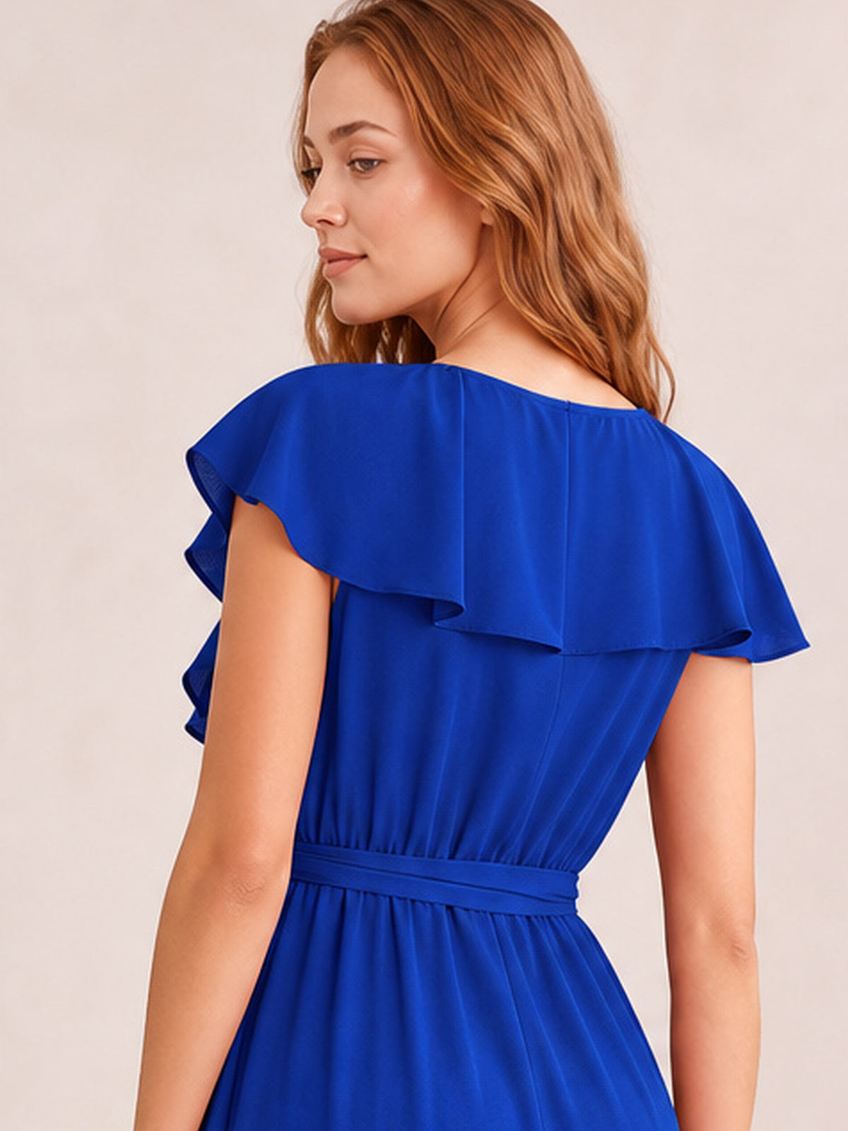 Model turns to show a vivid blue midi dress with layered ruffled flutter sleeves, a defined tied waist, and a softly draped silhouette.