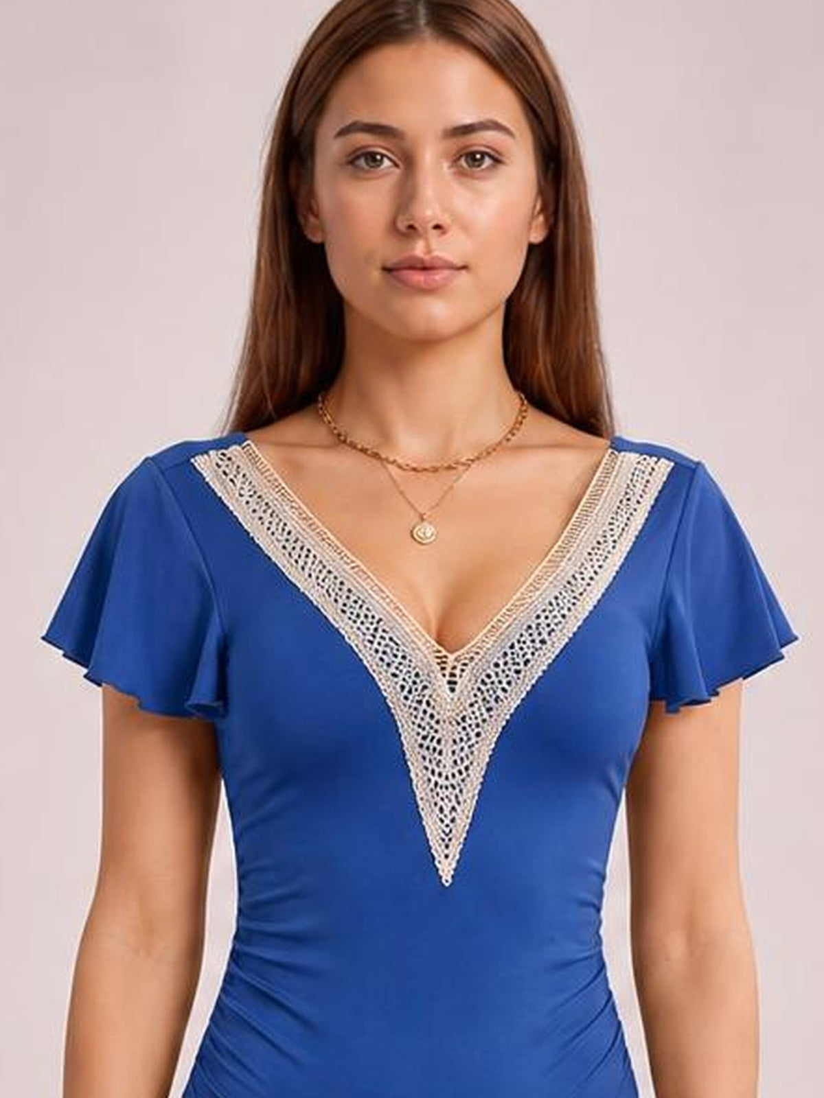 Front-facing model wears a royal blue one-piece swimsuit with a V-neck, white lace trim, and ruffled cap sleeves creating a fitted silhouette.