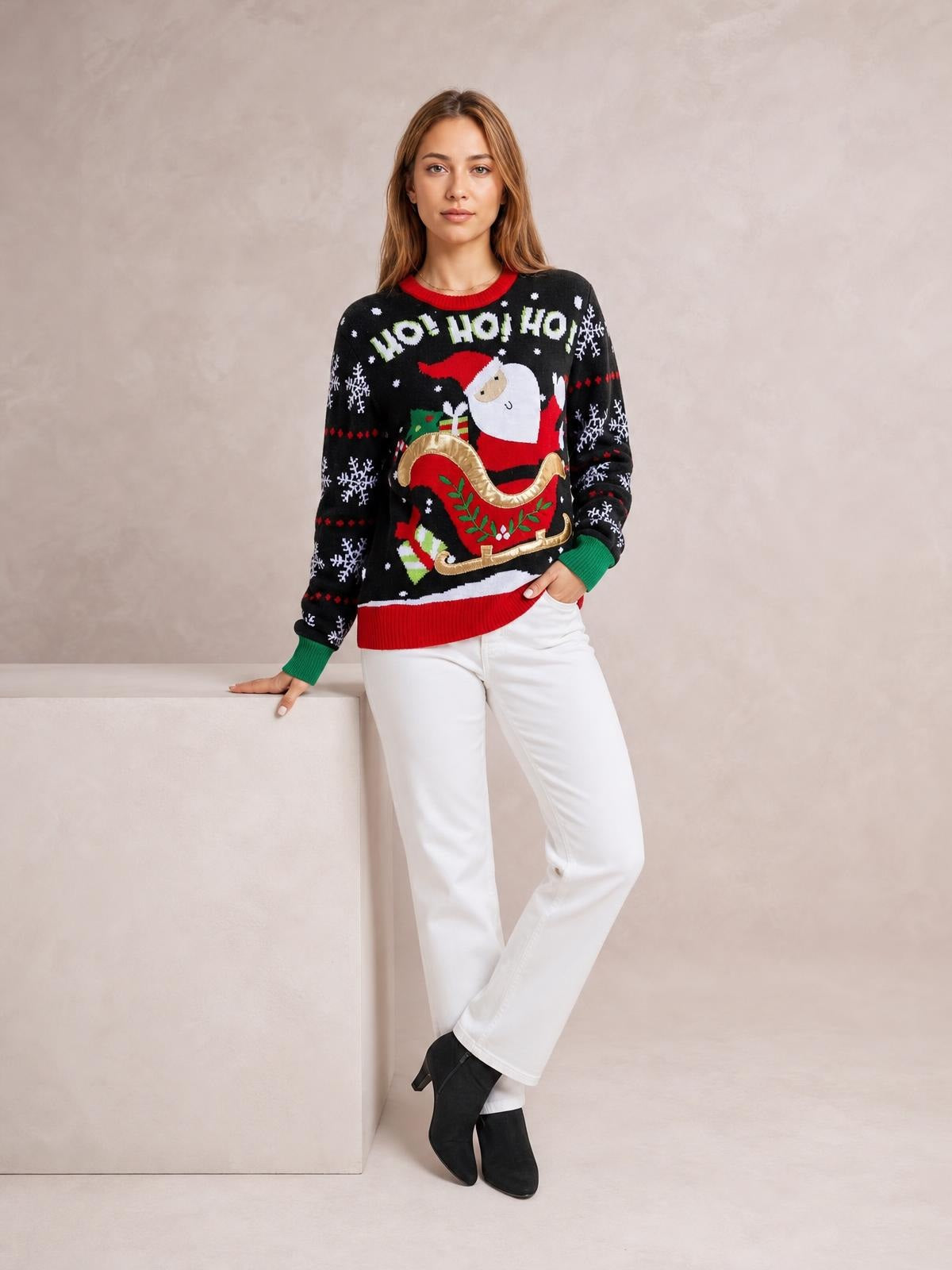 A woman poses in a black Santa graphic round-neck sweater with long sleeves, red and green ribbed trim, and a relaxed silhouette.