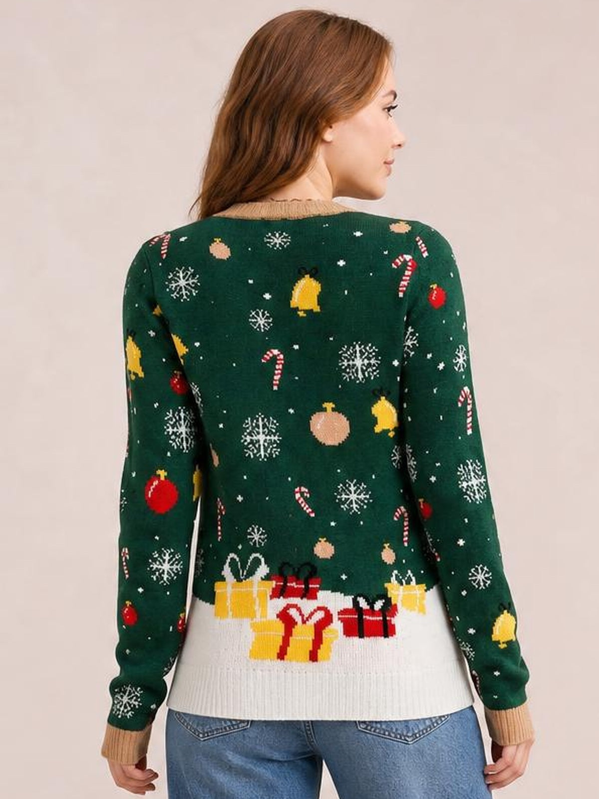 Back view of a woman wearing a dark green round-neck long-sleeve sweater with festive snowflake, ornament, candy cane, and gift patterns, ribbed cuffs and hem.