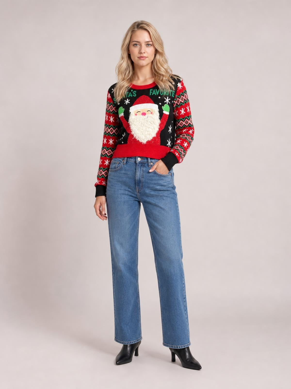 Model wears a black SANTA’S FAVORITE graphic long sleeve sweater with red and green holiday patterns, ribbed trim, and a relaxed silhouette.