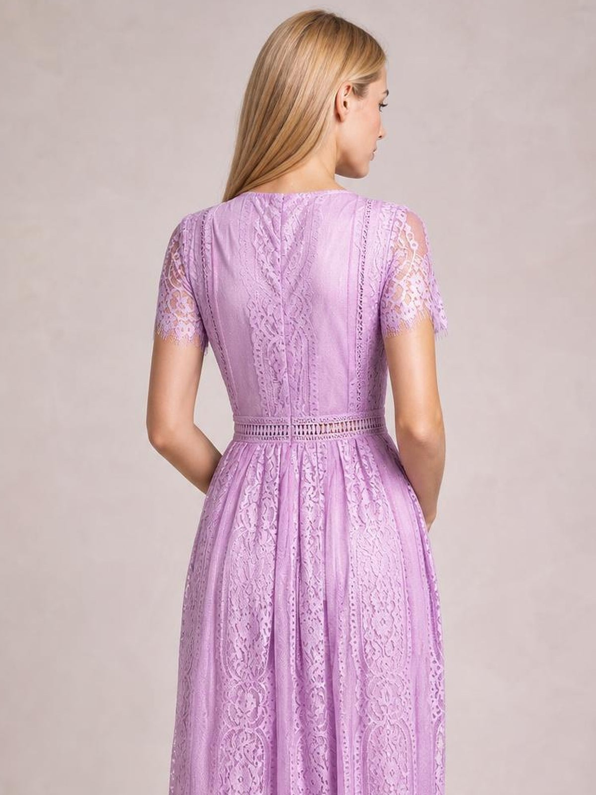 Model shown from behind in a lilac scalloped-trim lace maxi dress with short sleeves, a fitted waist, and a softly flared silhouette.