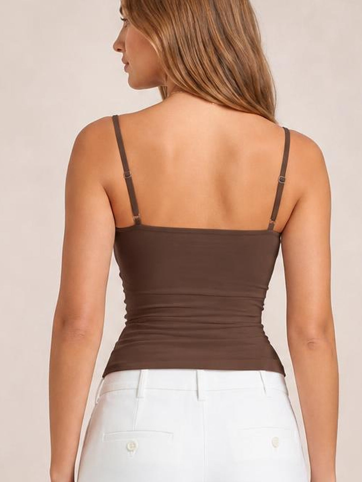 Model shown from the back wearing a dark brown scoop neck cami with thin adjustable straps and a fitted, stretchy silhouette.