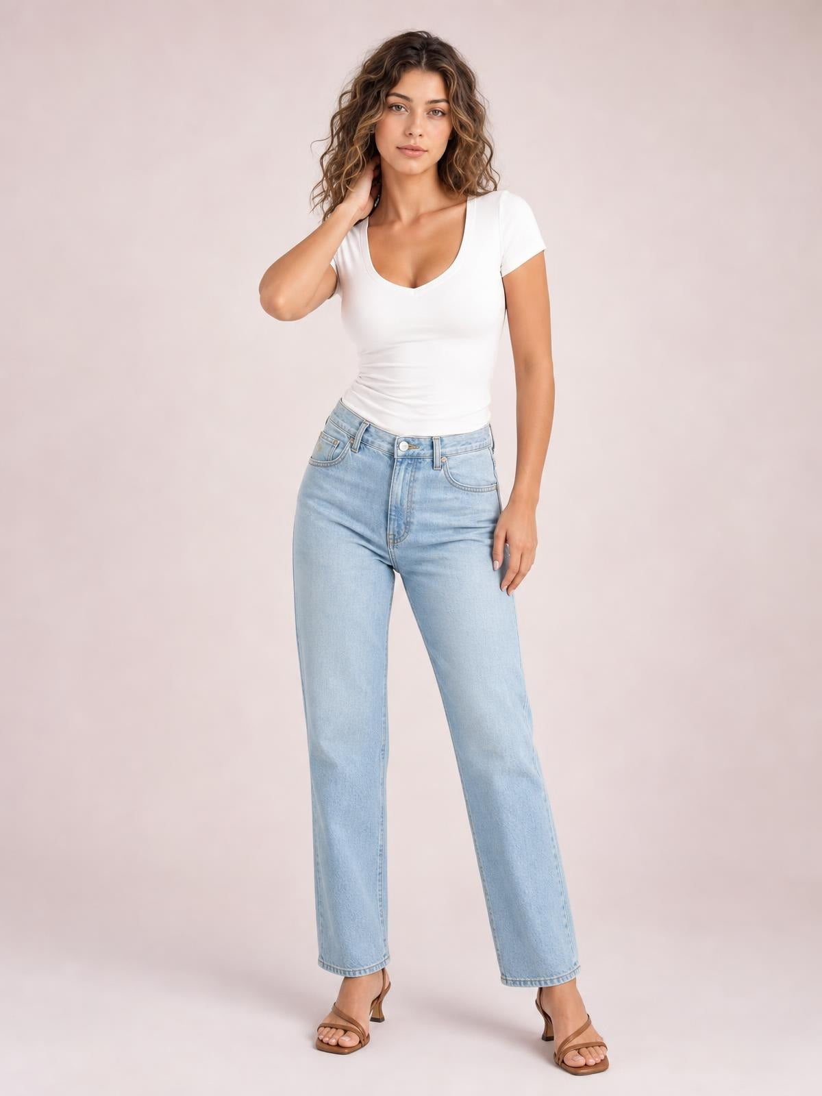 A model poses in a fitted white scoop neck short sleeve T-shirt with a smooth silhouette, one hand touching her hair and the other at her side.