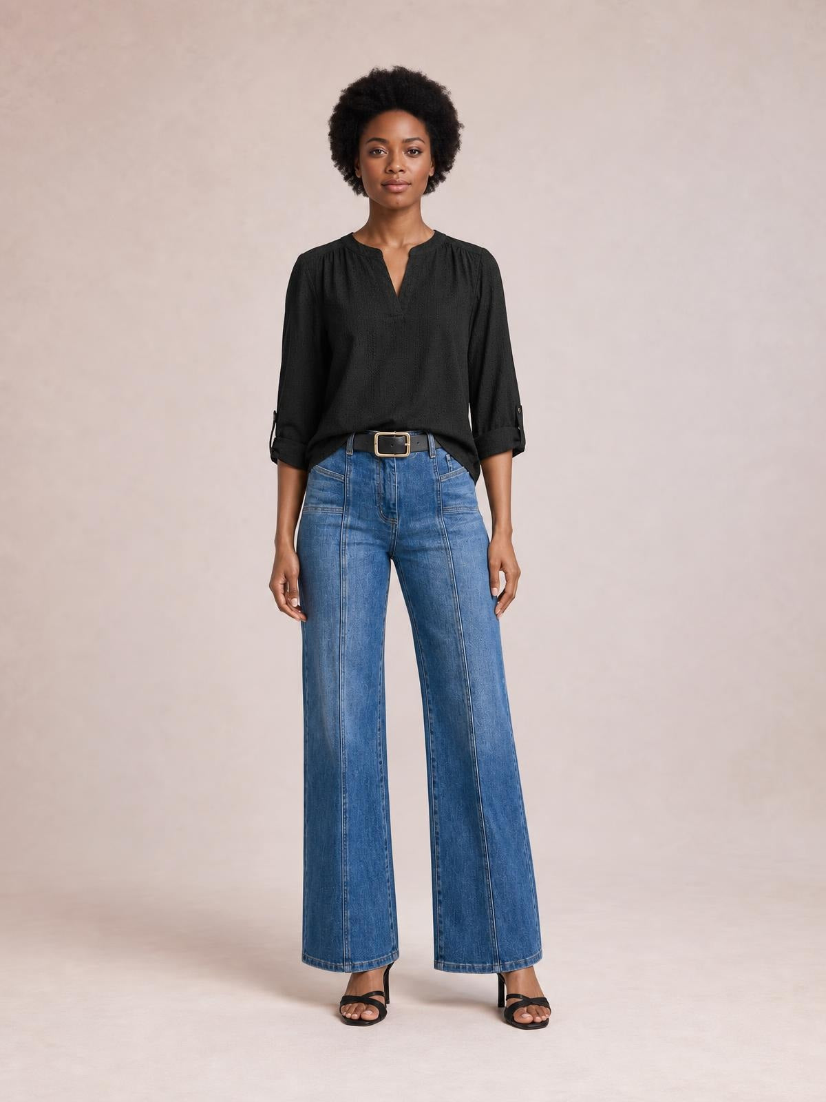 Model stands facing forward in blue shift jeans with a wide-leg silhouette, front seam detailing, belt loops, and front pockets.