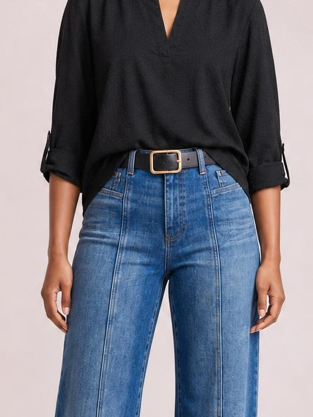 Model displays blue seam detail shift jeans with a high waist, front pockets, straight-leg silhouette, and contrasting vertical panel stitching.