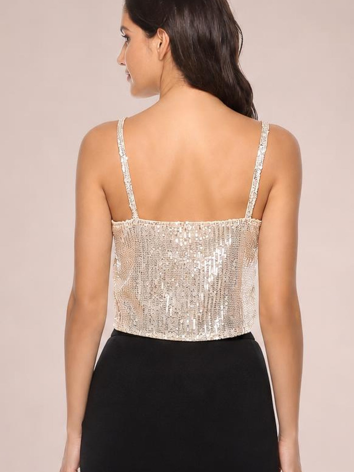 Model shown from behind wearing a silver sequin cropped cami with thin spaghetti straps and a fitted, straight silhouette.
