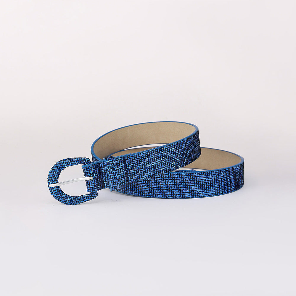 Blue sequin PU leather belt shown coiled to highlight its sleek 1.1-inch width, allover shimmer, smooth construction, and coordinated rounded buckle.