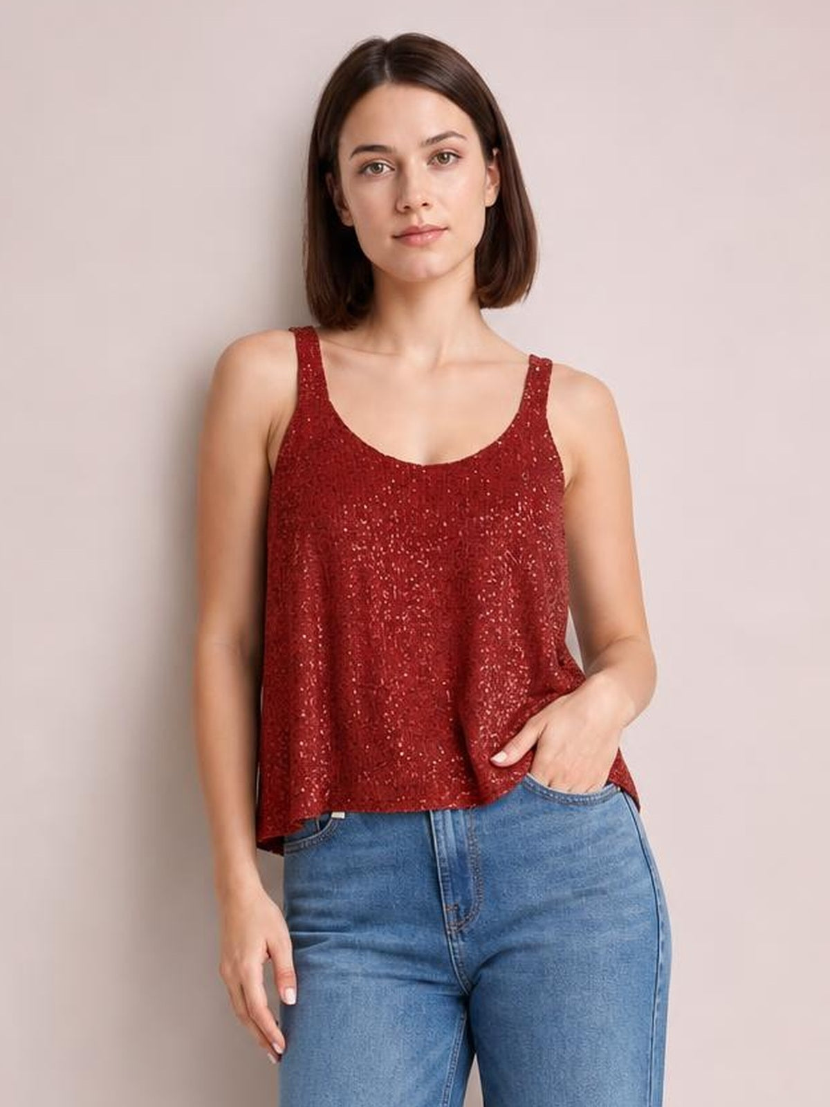 Model in a relaxed pose wears a burgundy sequin scoop neck tank with wide straps and a loose, slightly flared silhouette.