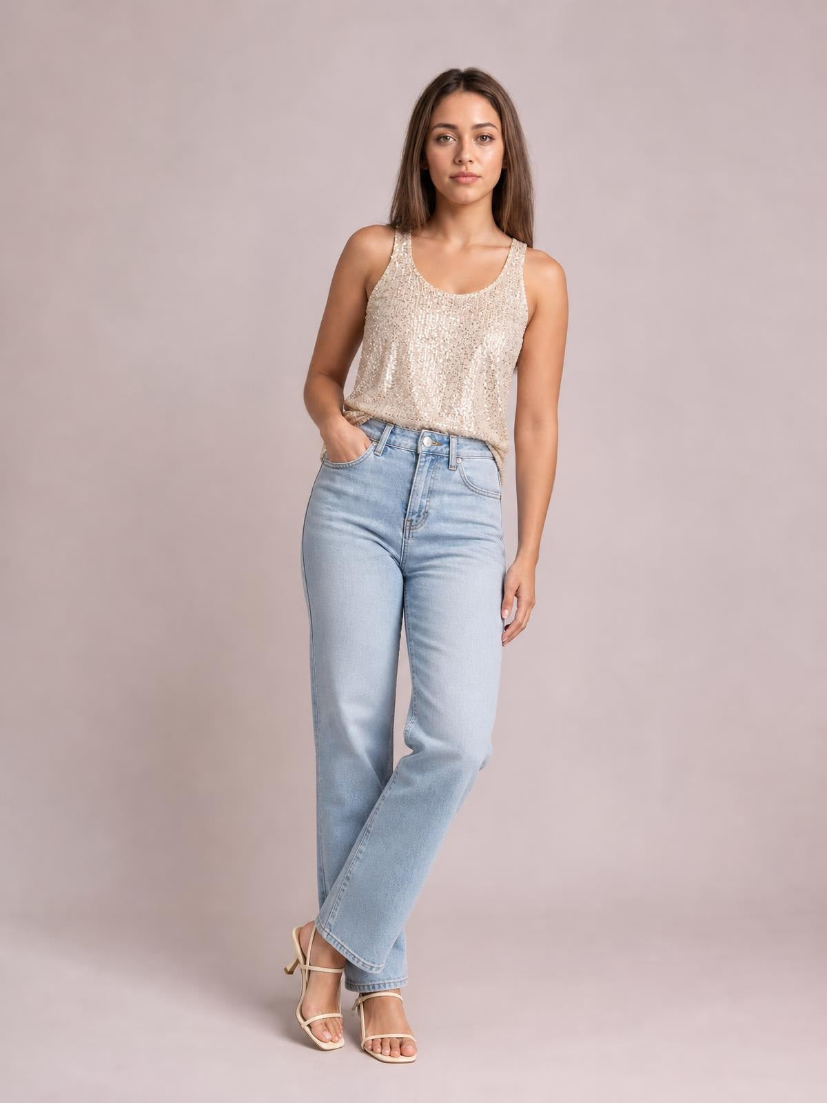 Model poses in a cream sequin scoop neck tank with a relaxed straight silhouette, wide shoulder straps, and a slightly tucked hem.