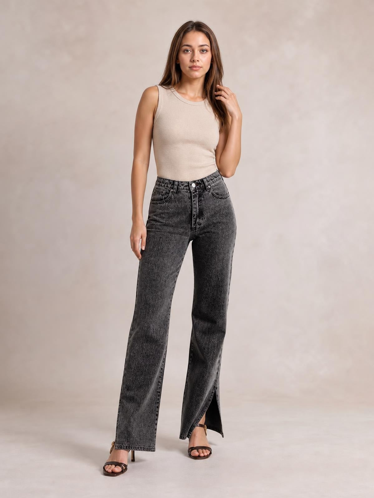 Model poses in dark gray wide-leg jeans with front pockets, a high-rise waist, and visible side slits at the hems.