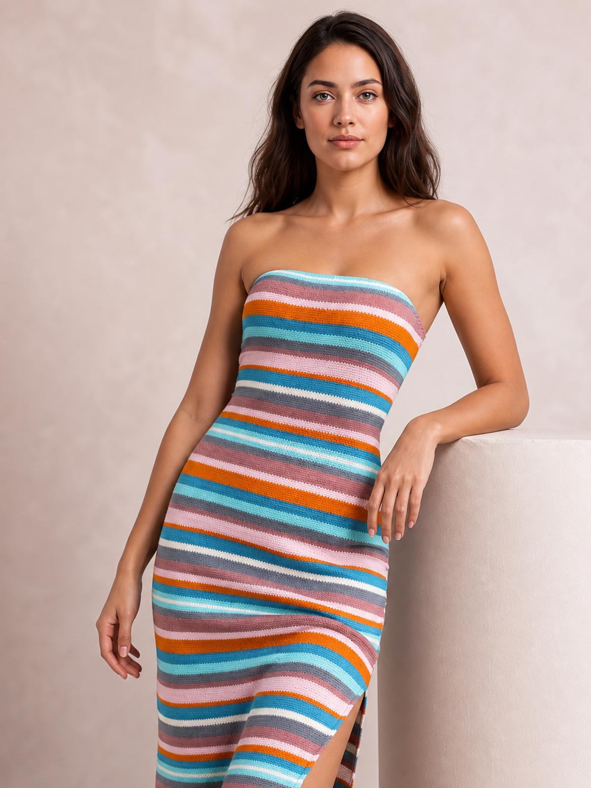 Model leans against a ledge in a colorful striped tube dress with a strapless neckline, body-skimming silhouette, long length, and side slit.