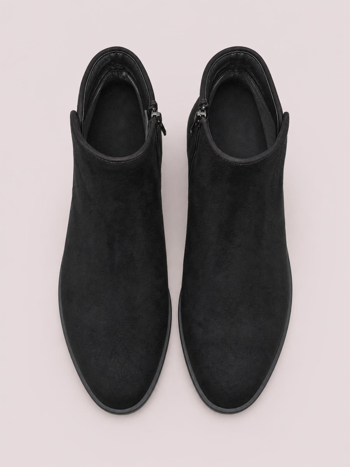 Pair of black suede wedge boots with rounded toes, ankle-height shafts, padded collars, side zippers, and dark rubber soles.