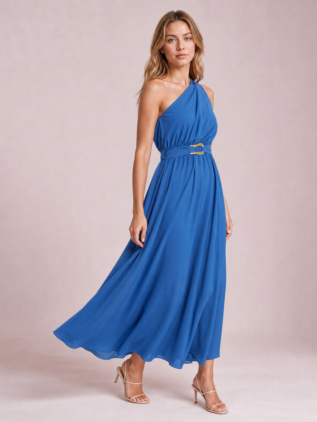 Model poses in a blue single shoulder midi dress with a softly gathered bodice, defined waist belt and flowing, flared skirt.