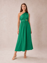 Model poses in a green single shoulder midi dress with a softly gathered bodice, defined waist, ring-detail belt, and flowing A-line skirt.