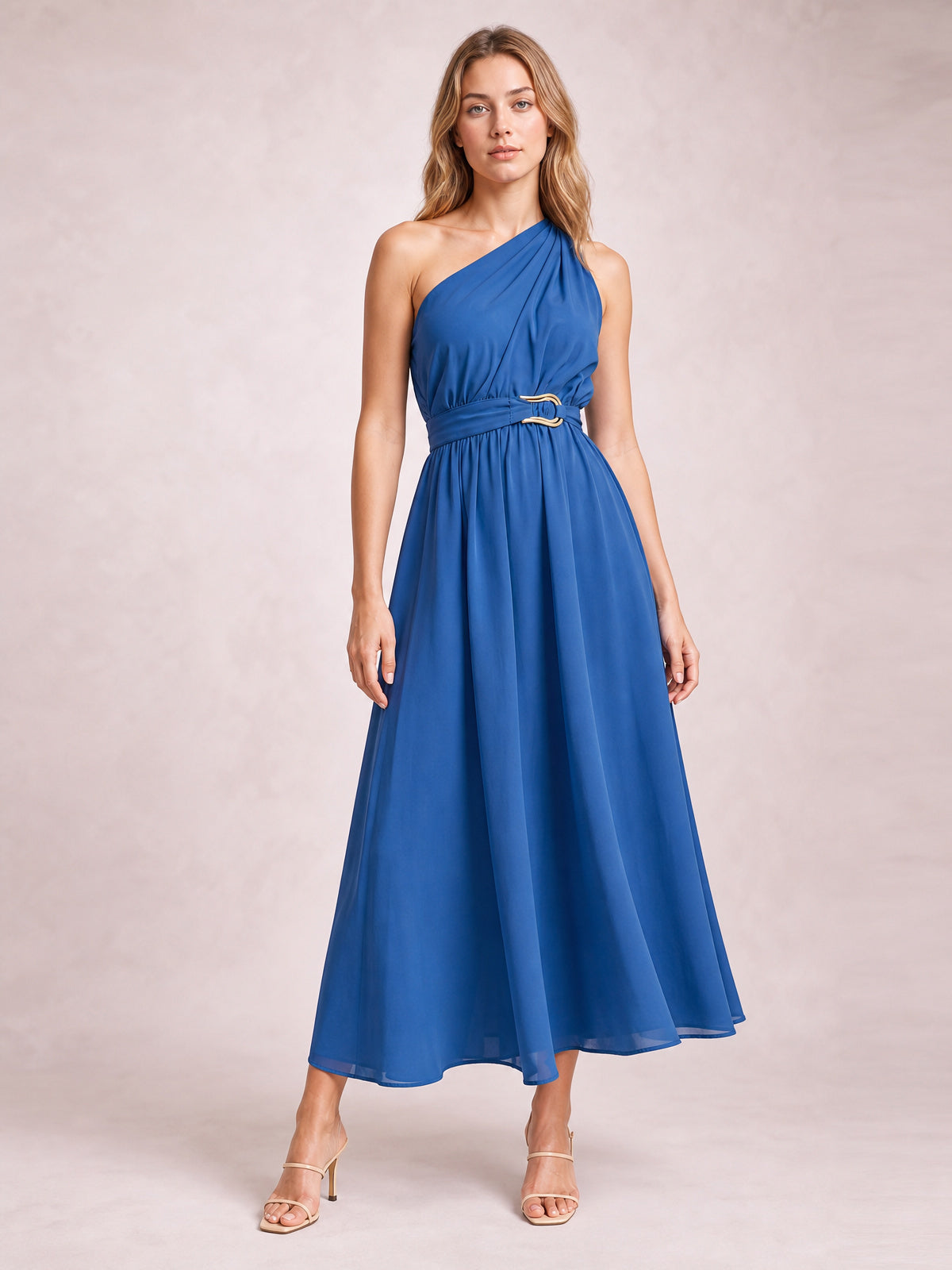 Model wears a blue single shoulder midi dress with gathered bodice, defined waist, ring-detail belt, and flowing A-line skirt.