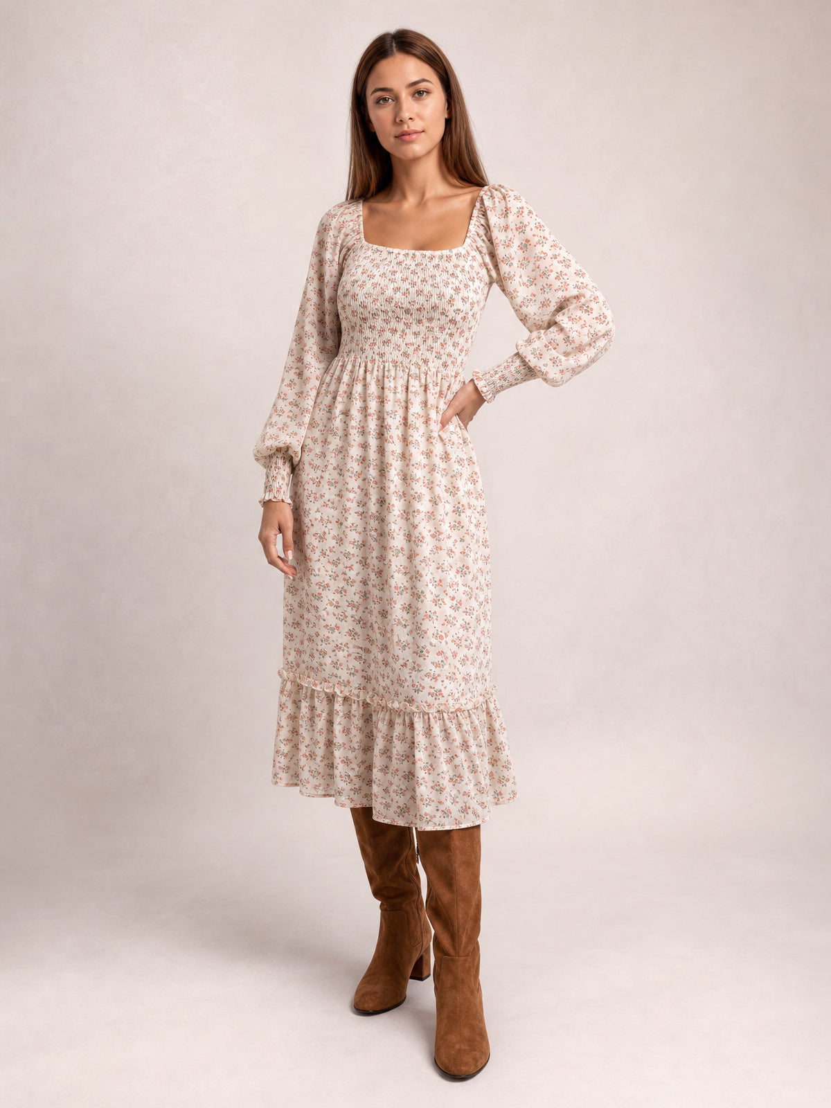 Model poses in a cream floral midi dress with a square neckline, smocked bodice, long puff sleeves, gathered waist, and flounced hem, paired with knee-high boots.