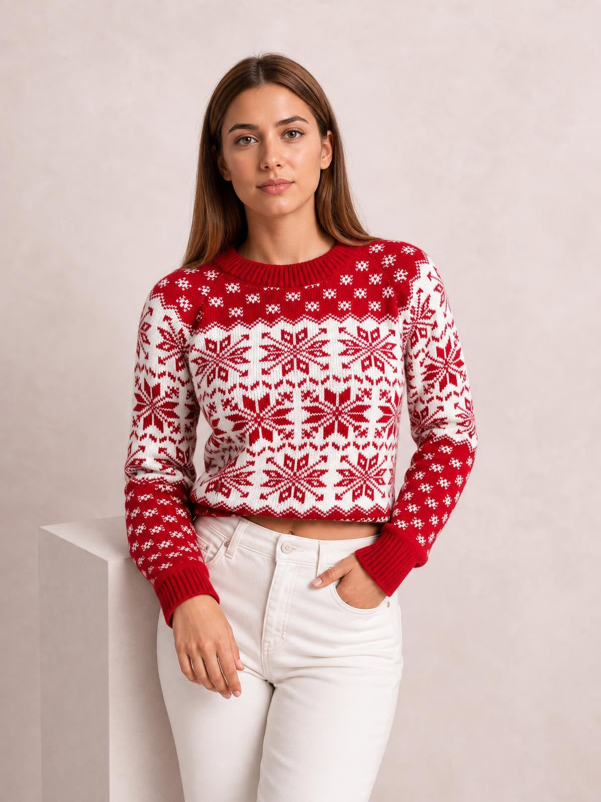 Model poses in a red and white snowflake pattern long sleeve sweater with a ribbed crew neckline, cuffs, and hem in a relaxed silhouette.