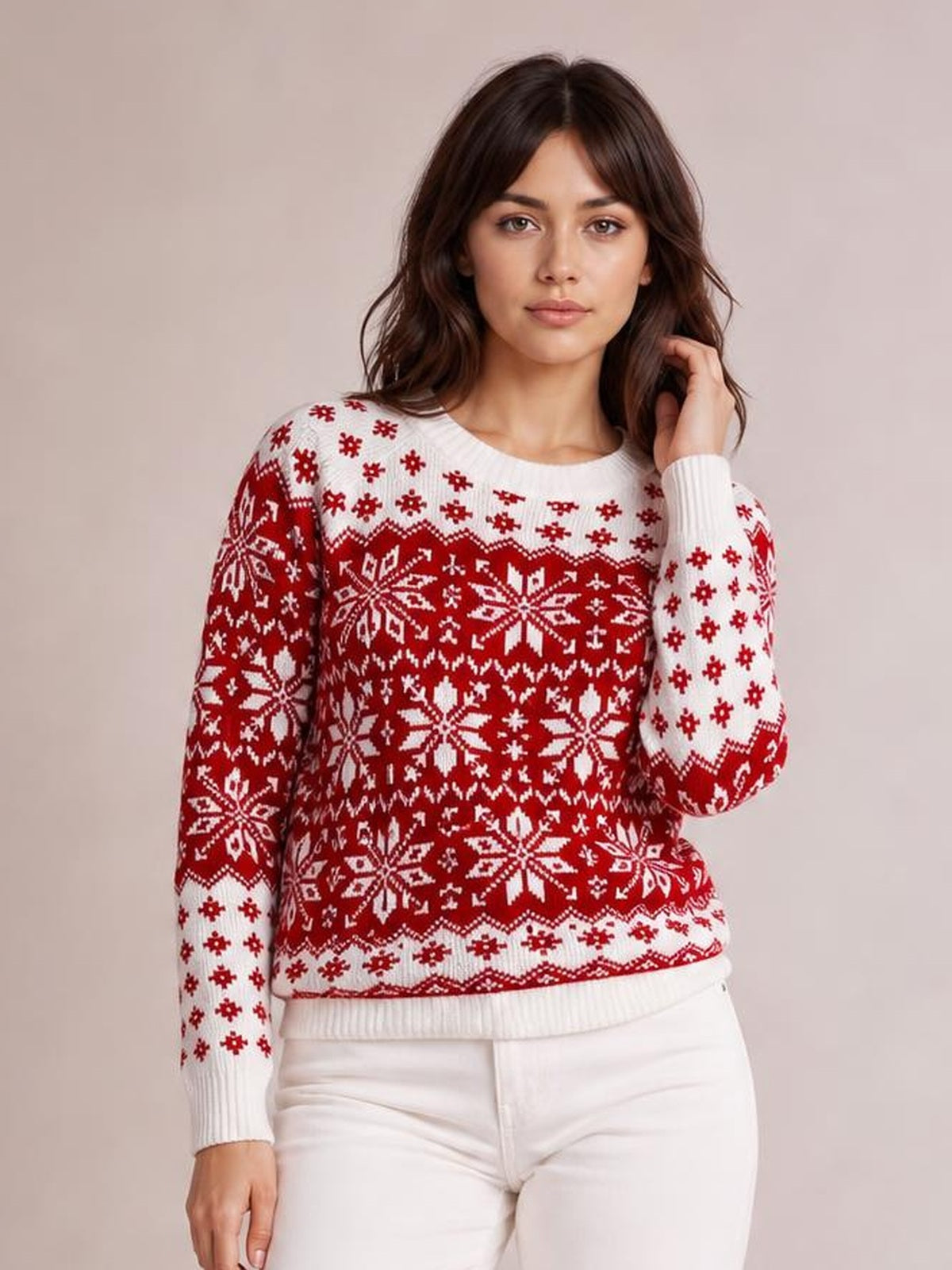 Model wearing a red and white snowflake pattern long sleeve sweater with a crew neck, ribbed cuffs and hem, and a relaxed silhouette.
