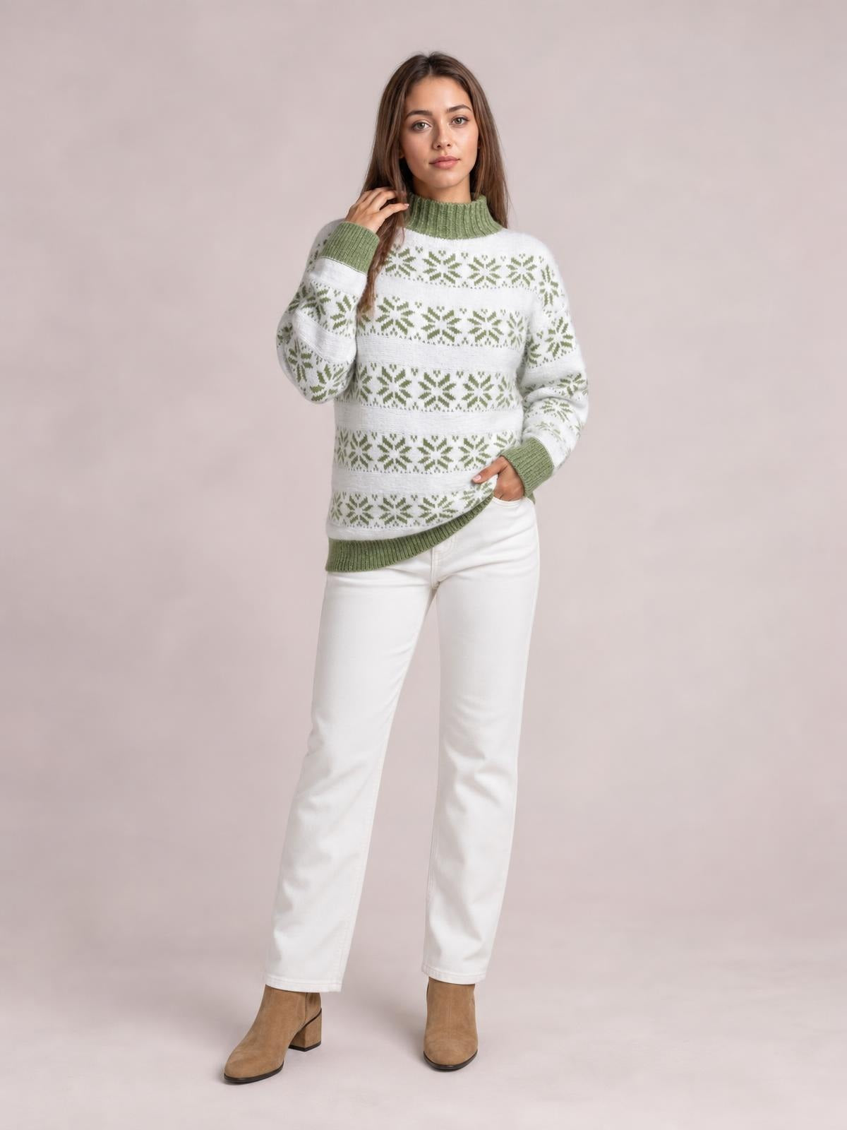 Model wearing a white and sage green snowflake pattern mock neck sweater with ribbed cuffs and hem, long sleeves, and a relaxed silhouette.