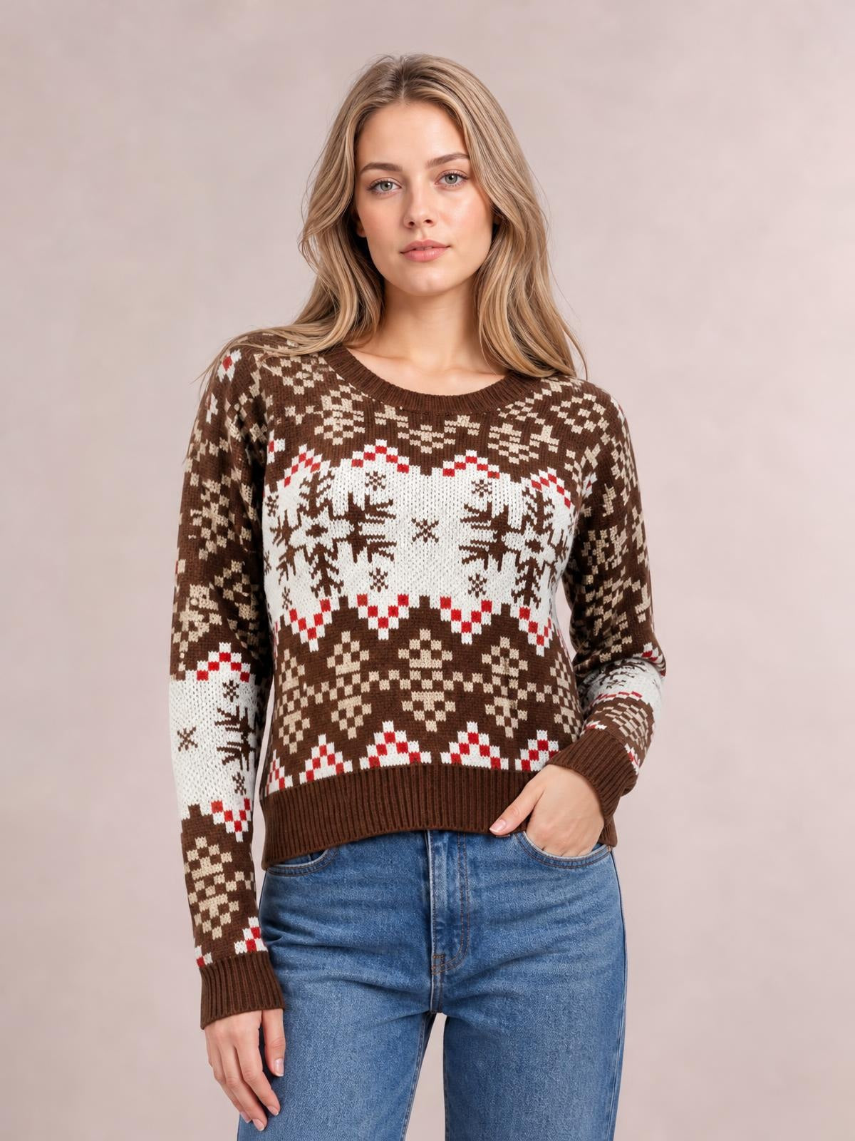 Model wears a brown round-neck sweater with white and red snowflake patterns, long sleeves, ribbed cuffs and hem, and a relaxed silhouette.