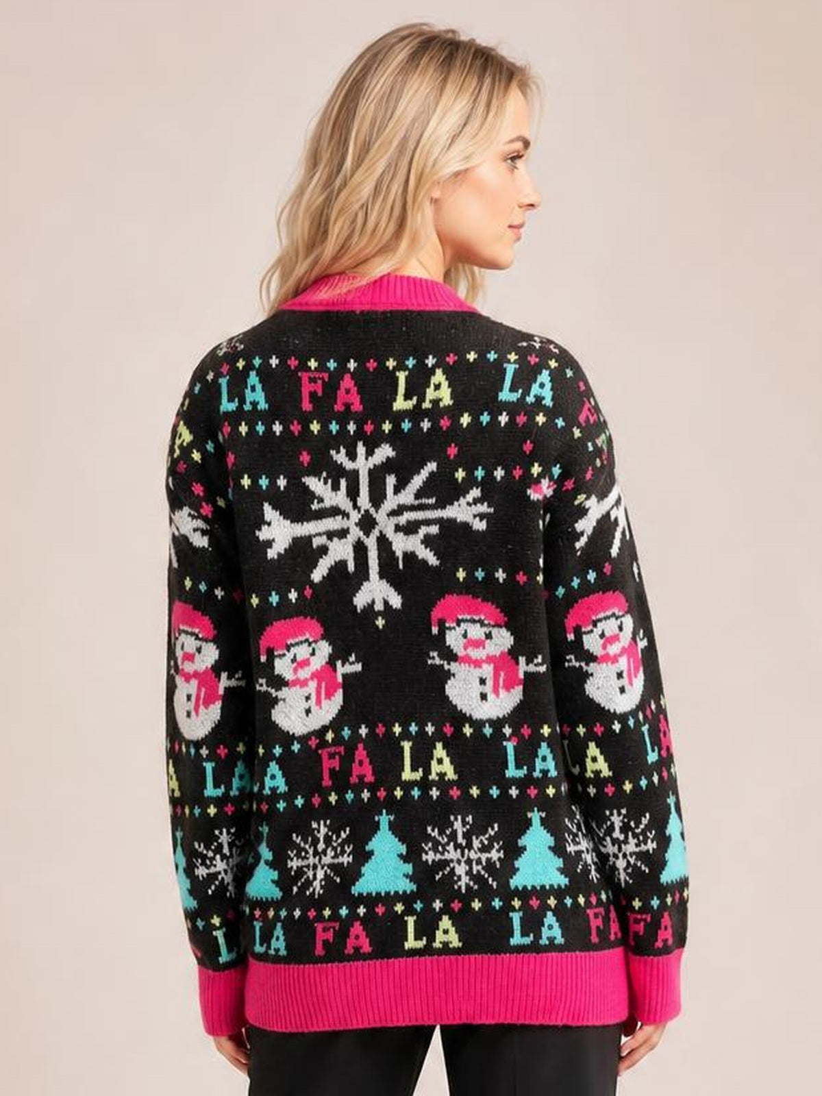 Back view of a model wearing a black snowman sweater with bright pink contrast trim, round neck, long sleeves, and a relaxed knit silhouette.