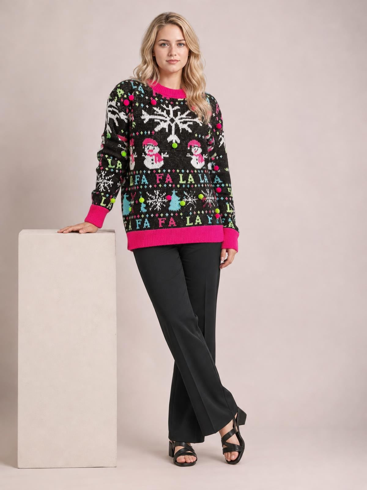 Model poses in a black Snowman contrast-trim round-neck sweater with pink ribbed cuffs and hem, long sleeves, and a relaxed festive knit silhouette.