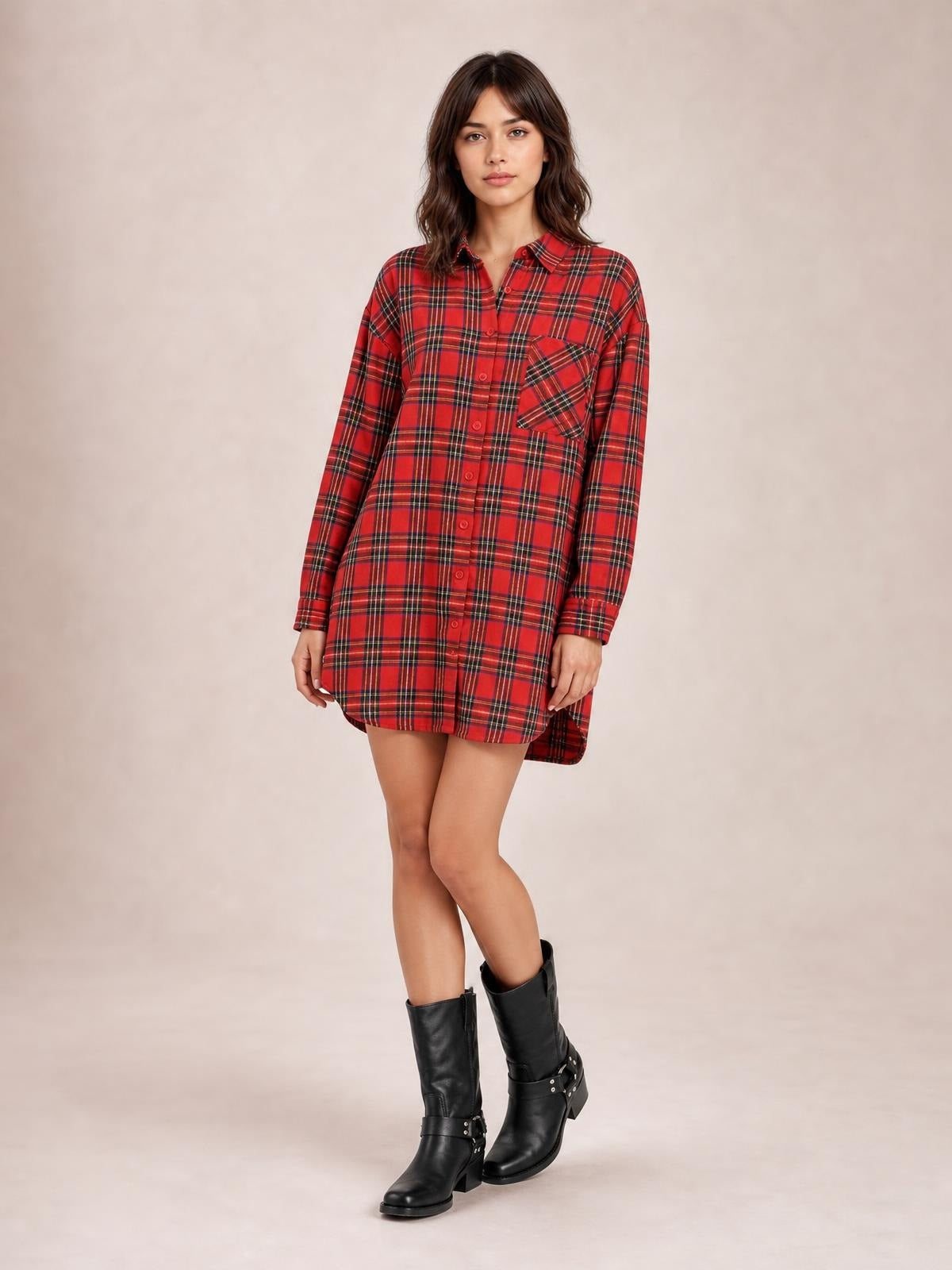 Model poses in a red Christmas checker plaid shirt dress with long sleeves, button-down front, chest pocket, oversized fit, and shirttail hem.