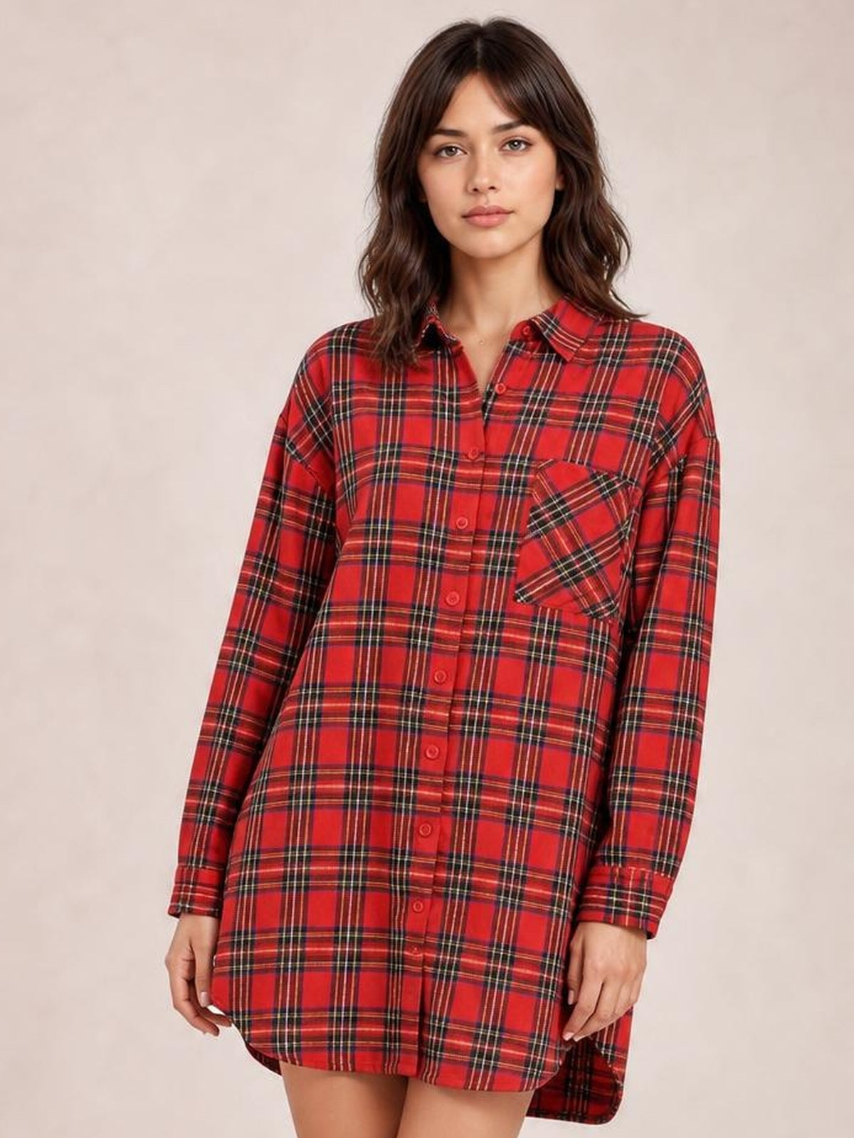 Model wears a red checker plaid shirt dress with long sleeves, button-down front, chest pocket, oversized fit, and rounded shirttail hem.