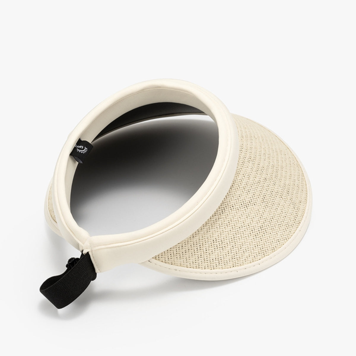 Cream woven natural grass visor with an open-top silhouette, gently curved brim, streamlined PVC trim, and adjustable black back strap.