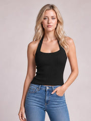 A model stands in a fitted black halter neck knit cami with wide straps, a softly scooped neckline, subtle vertical texture, and a clean cropped hem.