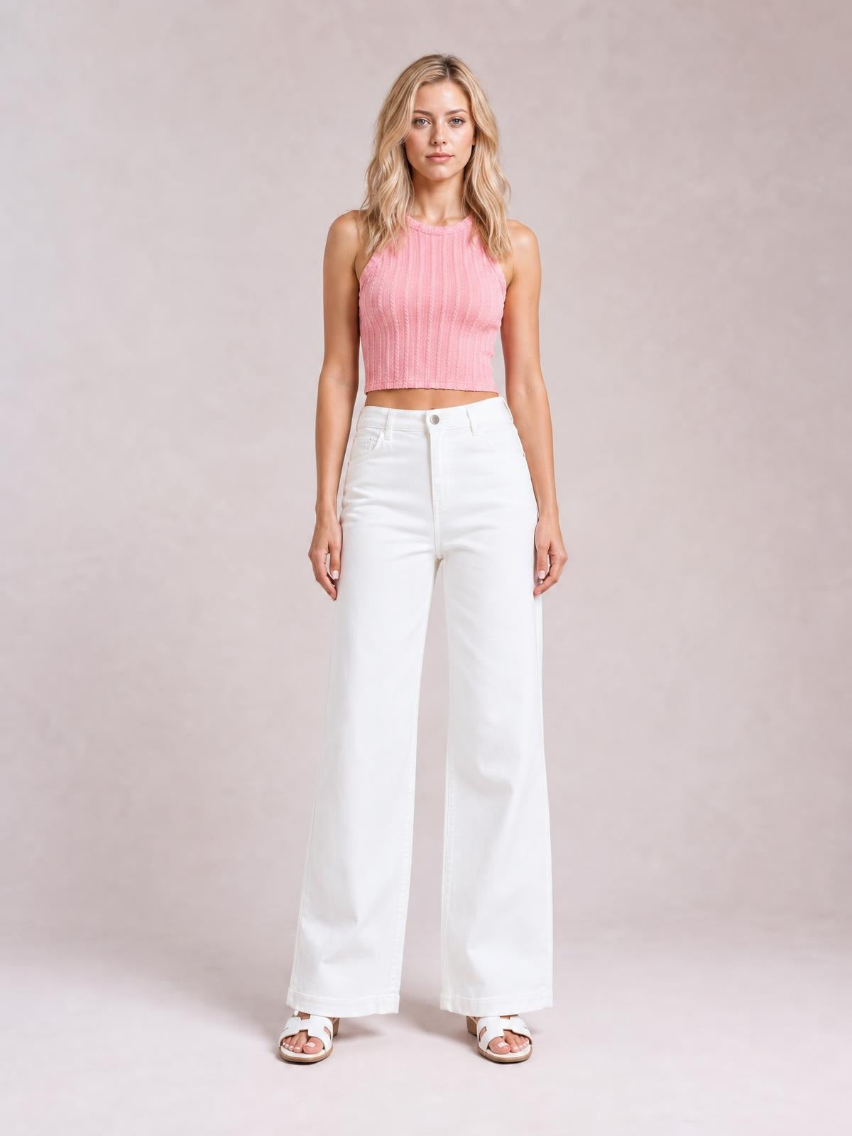 A model stands facing forward in solid white casual jeans with a button fly, front pockets, and a relaxed loose wide-leg silhouette with straight hems.