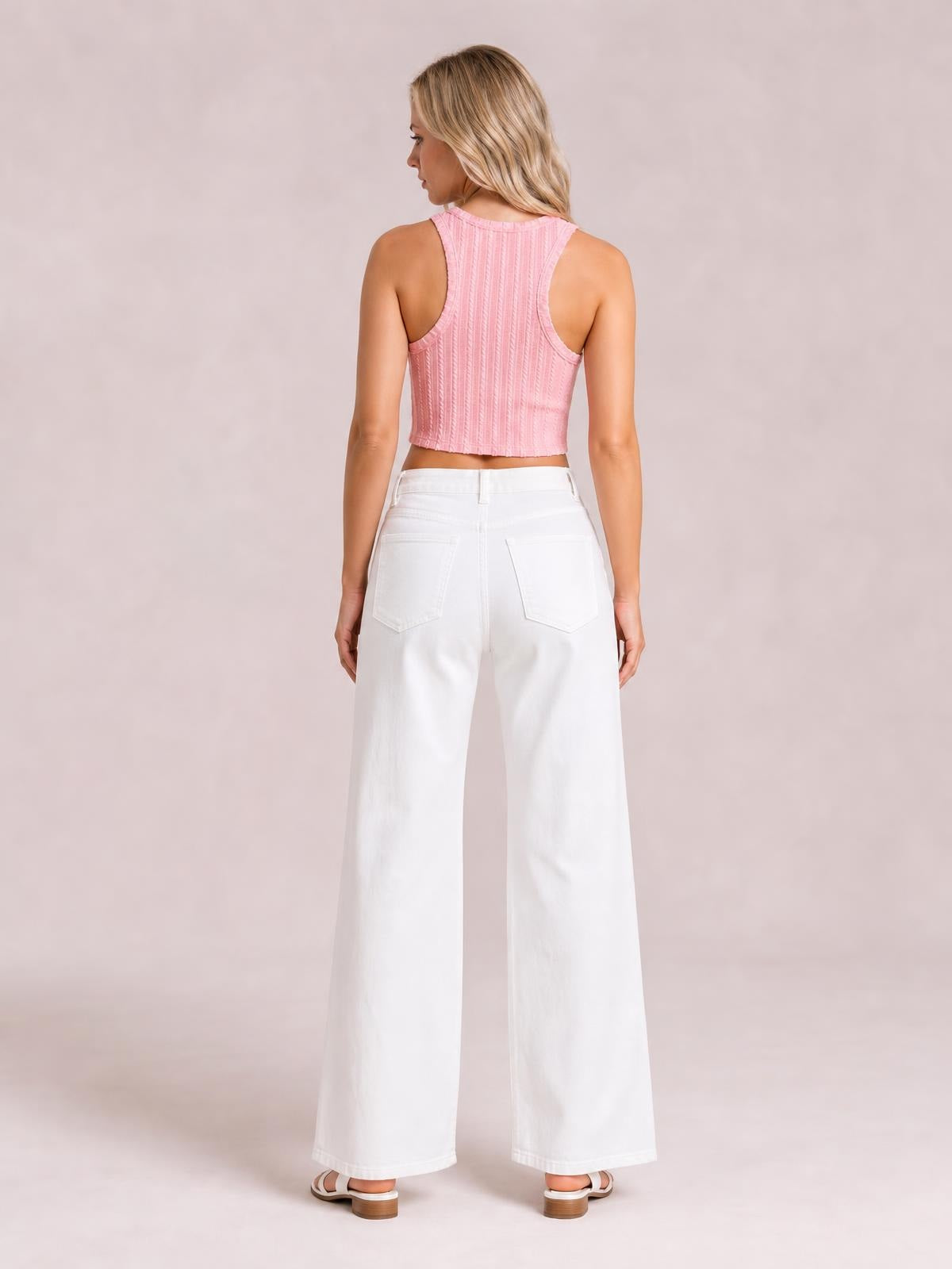 A model stands in rear view wearing solid white casual jeans with a high waistband, belt loops, back pockets, and a loose wide-leg silhouette.