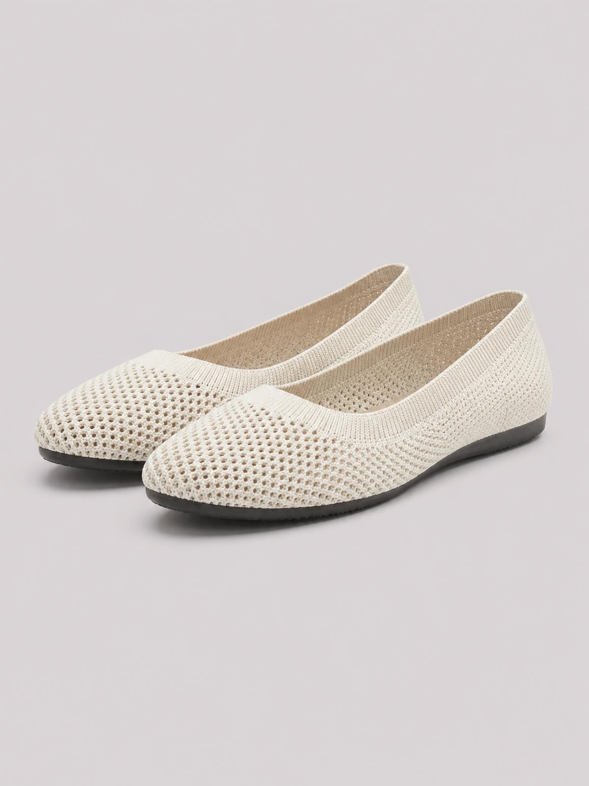 Cream solid-color mesh flat slip-on shoes with rounded toes, breathable perforated construction, and low black rubber soles.