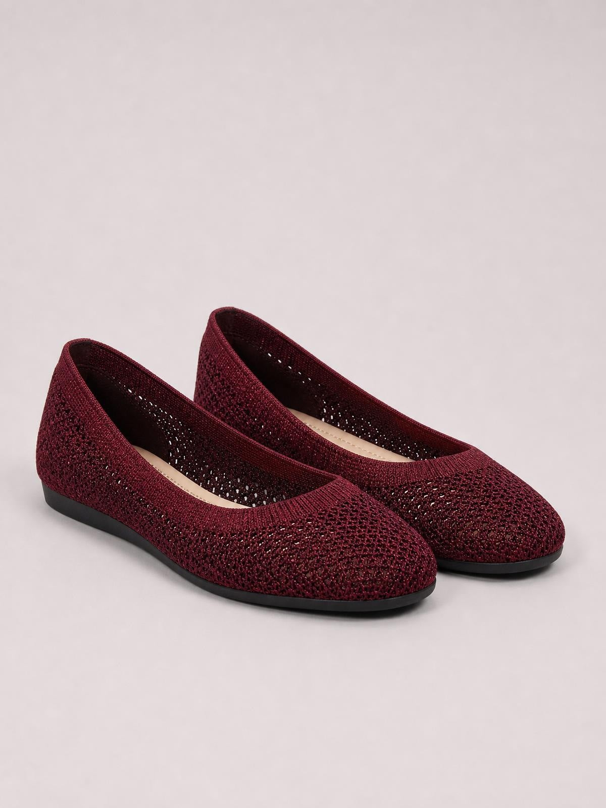 Burgundy solid-color mesh flat slip-on shoes feature rounded toes, breathable perforated uppers, low heels, and durable black rubber soles.